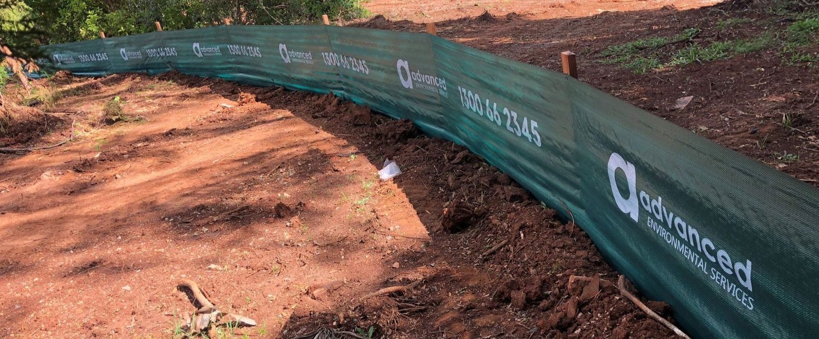 Green sediment control fence installed by Advanced Environmental Services